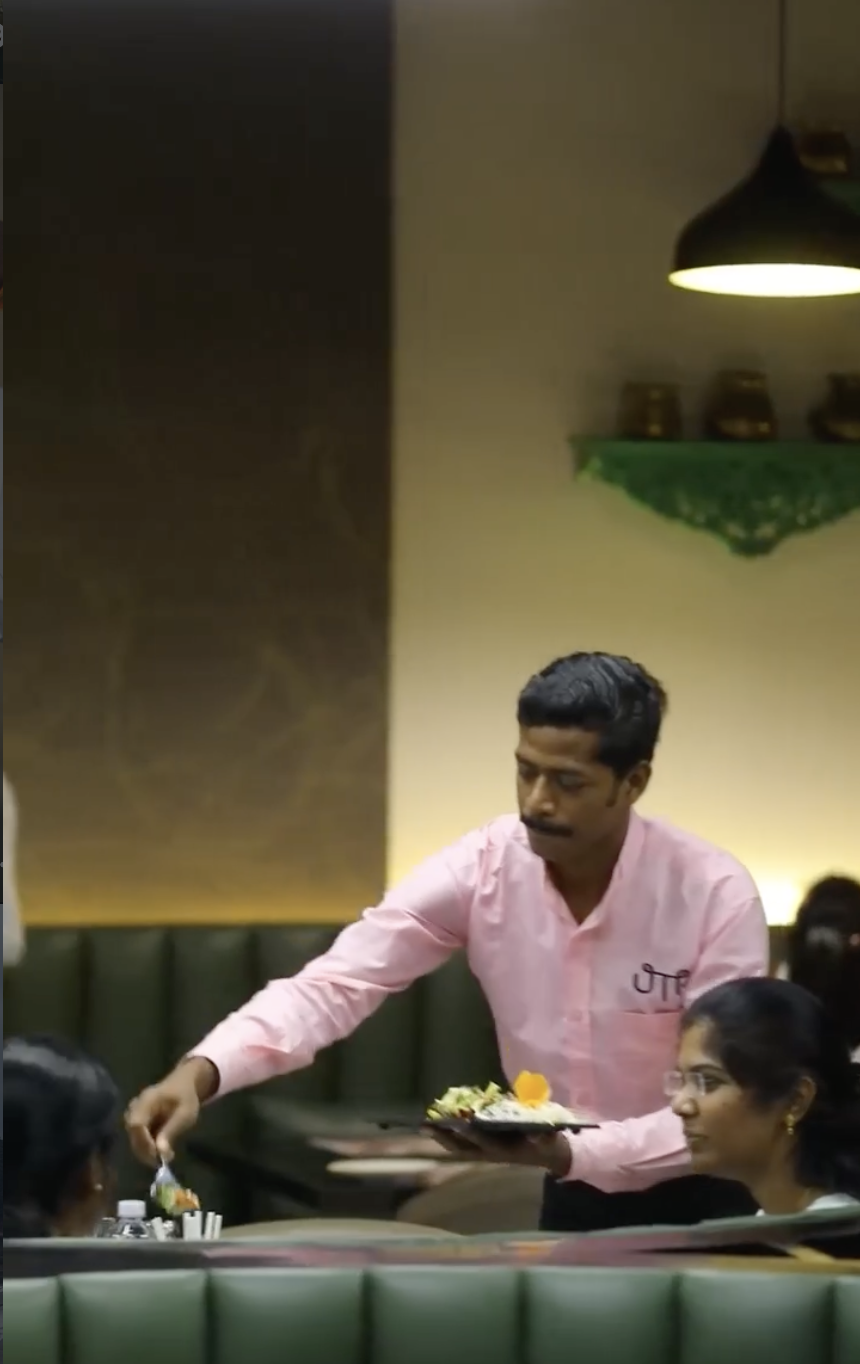UTK team member serving guests in the dining room