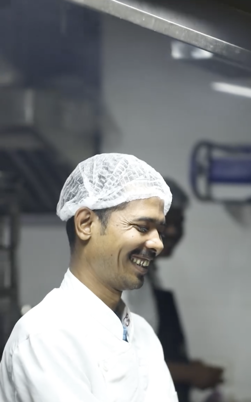 UTK chef smiling while working in the kitchen